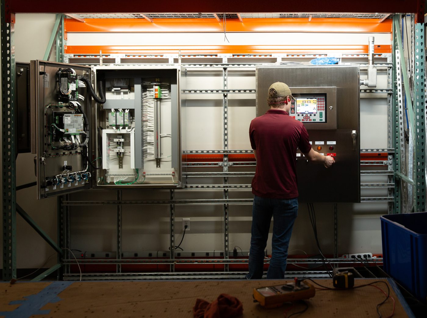 Drake Controls technician operating a Woodward turbine control panel in the Drake controls shop