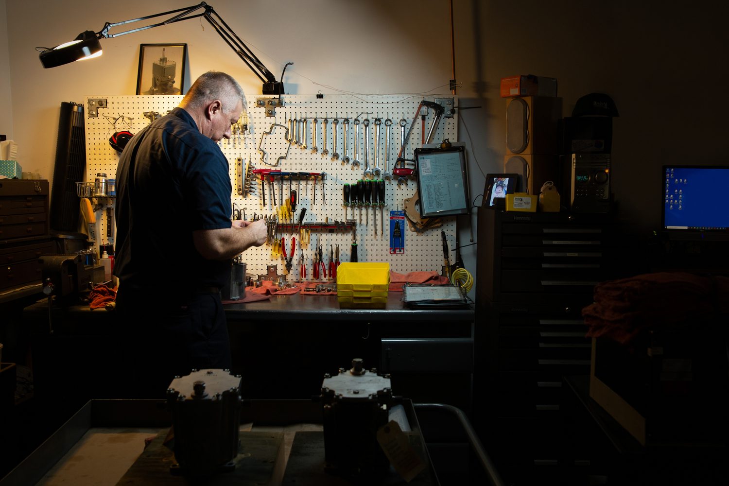 Experienced Drake Controls technician at a governor repair bench